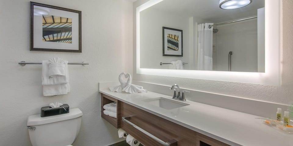 Refresh at a sleek vanity with glowing mirror light.