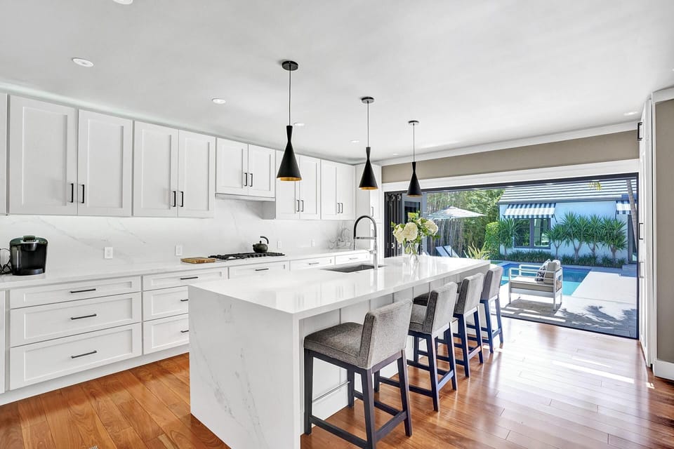 Luxury Kitchen with gas stove opens to outdoor living space, pool and breezeway