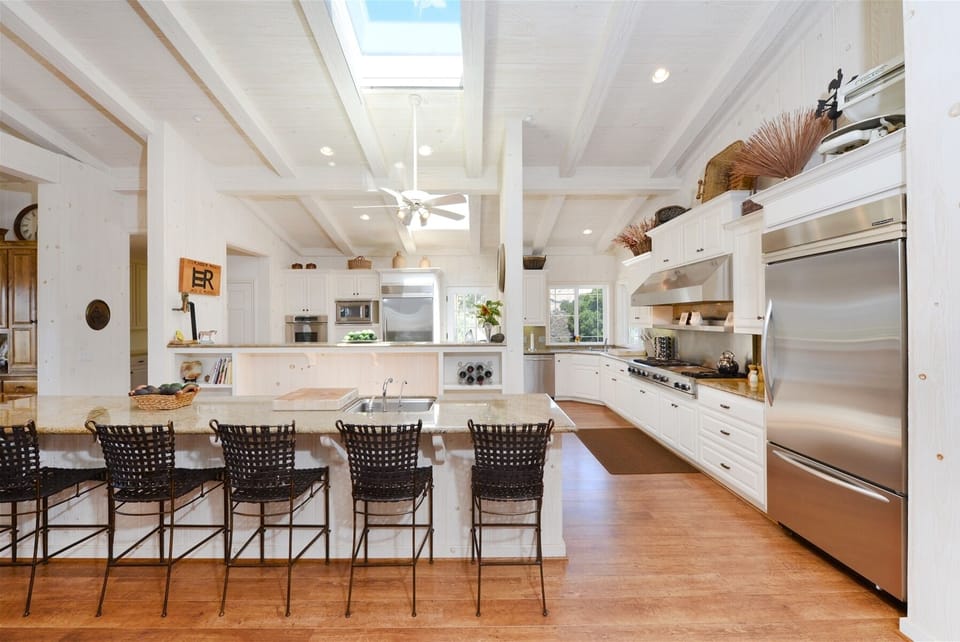 Incredible chef`s kitchen with high end six burner gas range, bar seating and upgraded stainless steel appliances