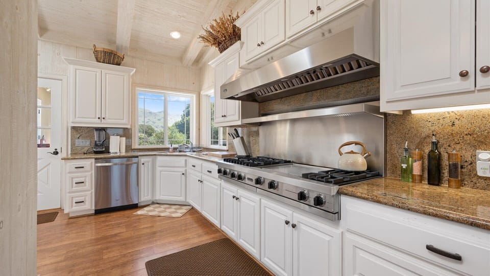 Incredible chef`s kitchen with high end six burner gas range, bar seating and upgraded stainless steel appliances