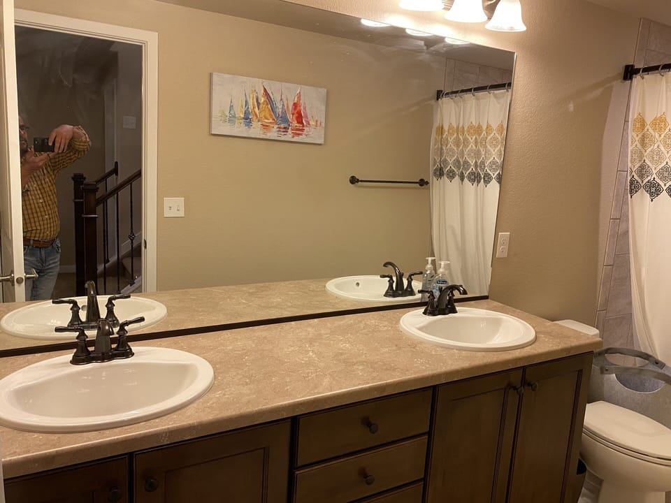 Bathroom with two sinks and towels for five