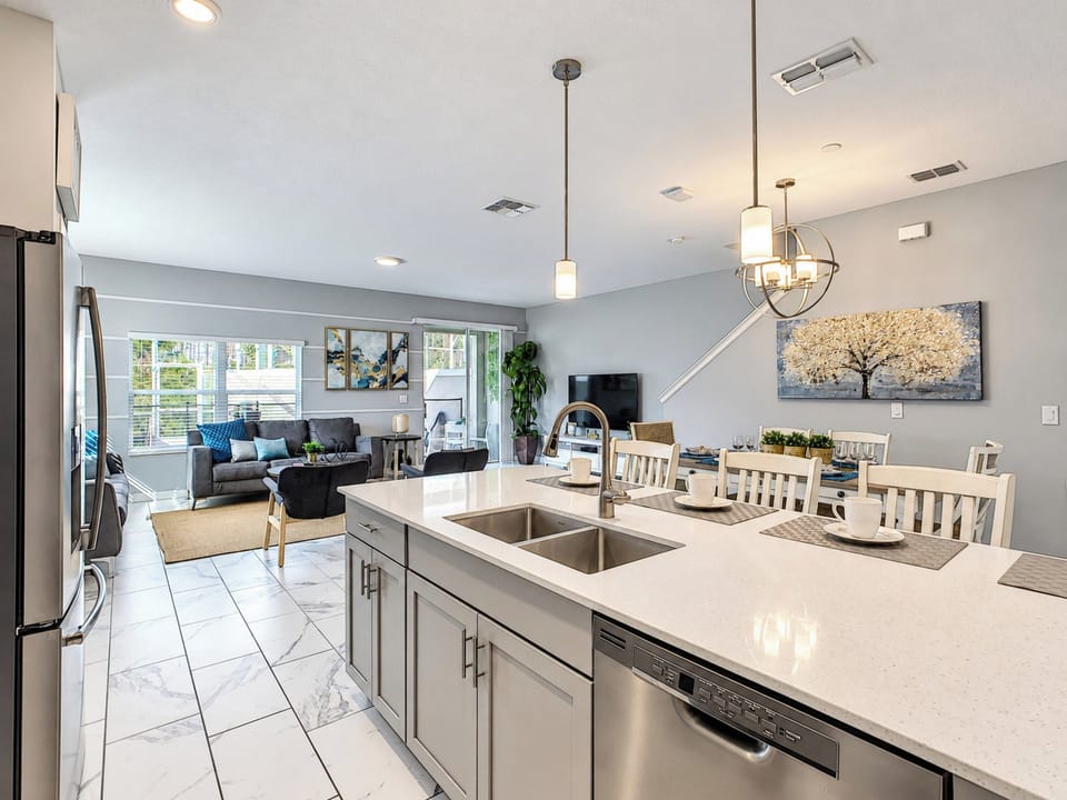 Modern Kitchen Island Overlooking Open Living and Dining Area