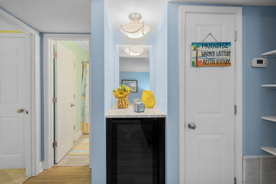 Your bright hallway welcomes you with cheerful coastal colors and thoughtful touches that set the perfect vacation mood.