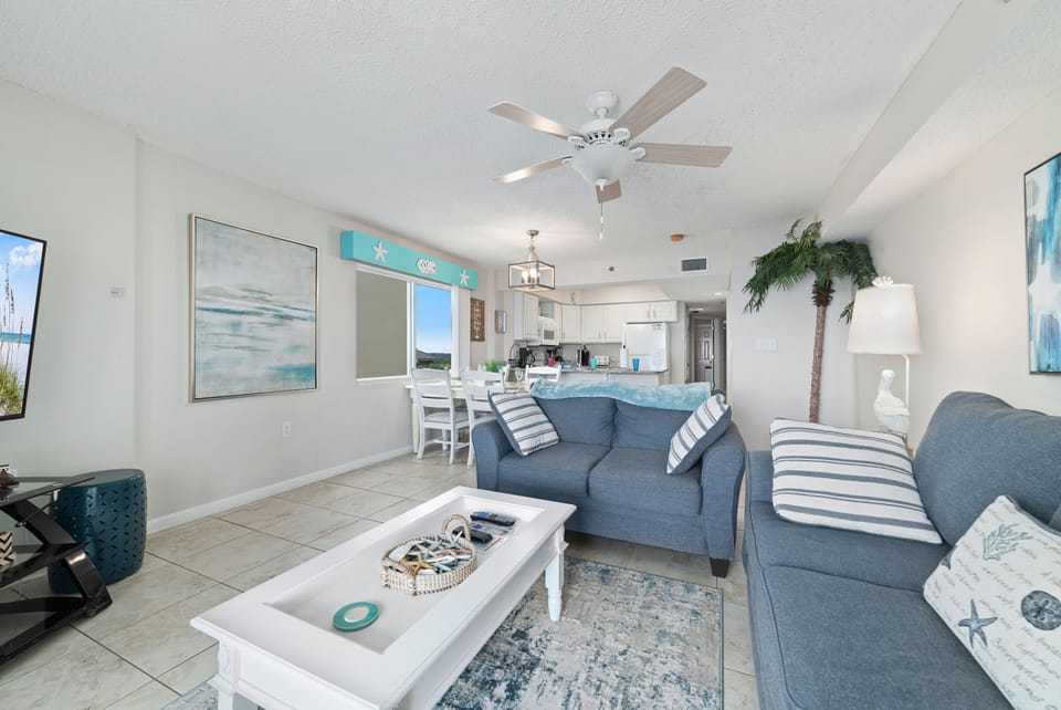 A comfortable living room with ample seating, flowing into a dining area, ideal for everyday living and gatherings.
