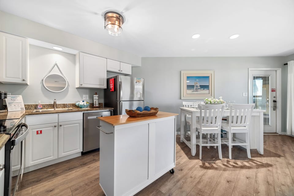 Prepare delicious meals in this beautiful, well-appointed kitchen featuring granite countertops, full-size appliances, and a convenient island for extra prep and storage.