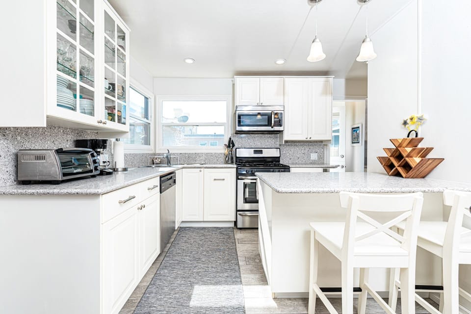 The bar area with bar stools is a perfect additional seating area so the house chef can cook with an audience!
                