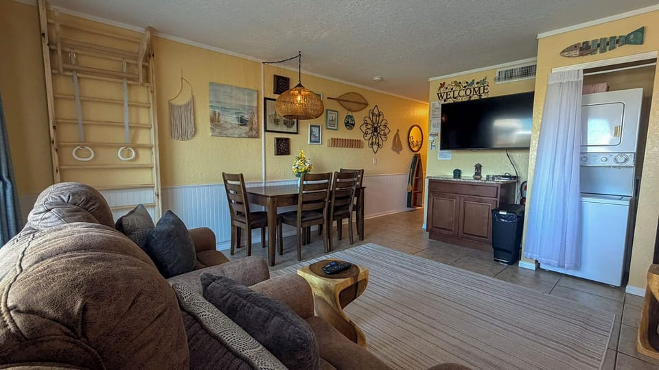 Relax in your cozy living space featuring plush seating, rustic dining area, and convenient kitchen access—perfect for unwinding after your adventures.