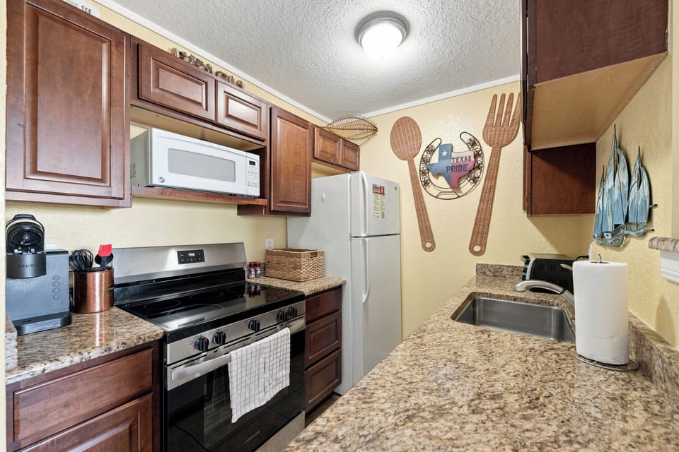 Step into your fully equipped kitchen with granite countertops, stainless appliances, and all the essentials to cook up your favorite meals during your stay.