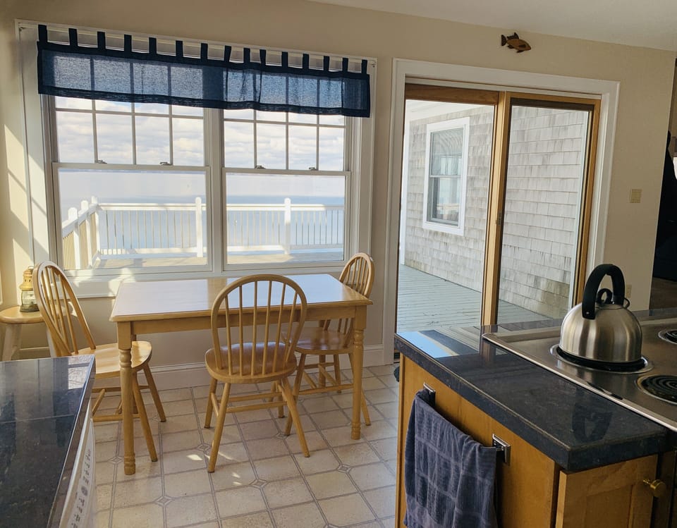 Eat-in kitchen with deck access. Kitchen is open to our dining and living room. 