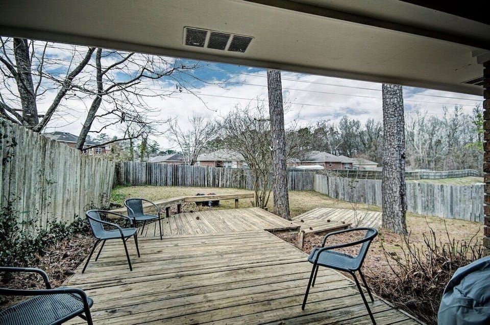 Awesome outdoor area with a three tier deck and plenty of seating. The back is partially fenced. 