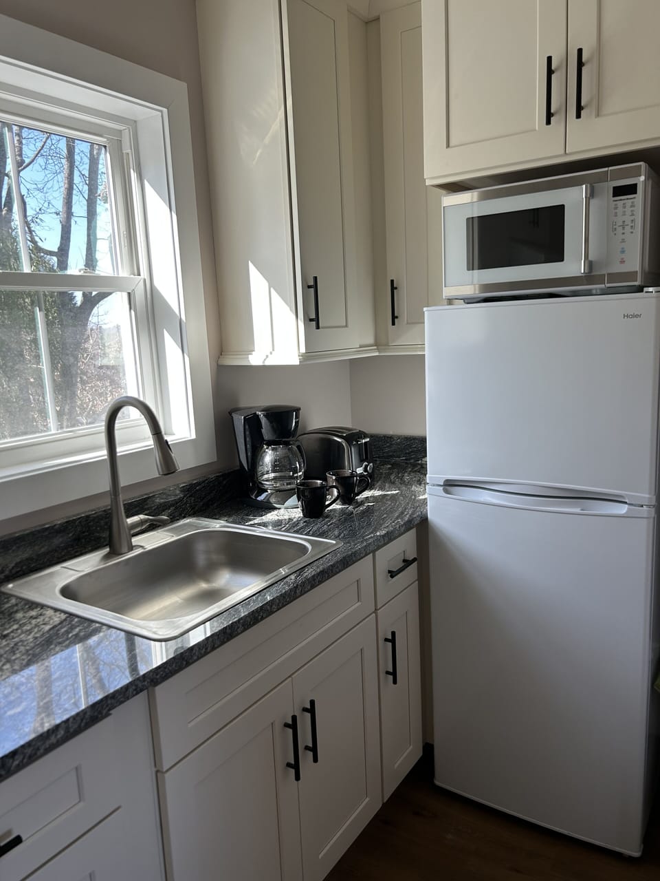 It is fully stocked with a coffee maker, toaster, blender, and microwave.