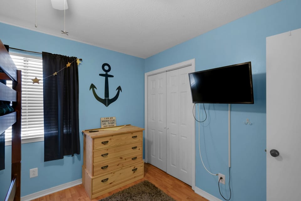 Bunk room with flat screen TV