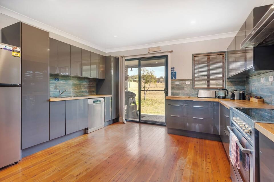 The kitchen is fully equipped including a stove and oven, microwave, kettle, pots and pans and a dishwasher for easy cleanup.