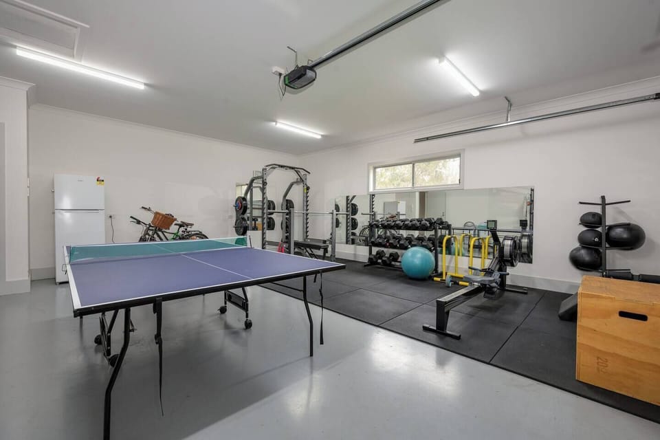 Get active in the converted garage with a full home gym and a ping pong table.