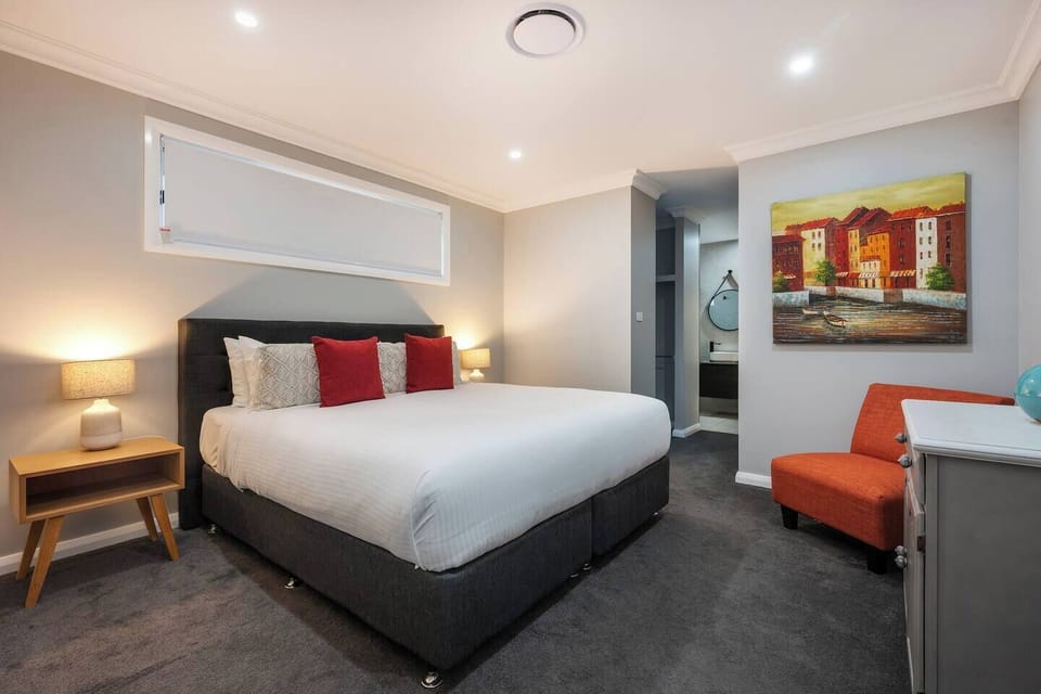 The stylish primary bedroom features a king bed and an ensuite bathroom.