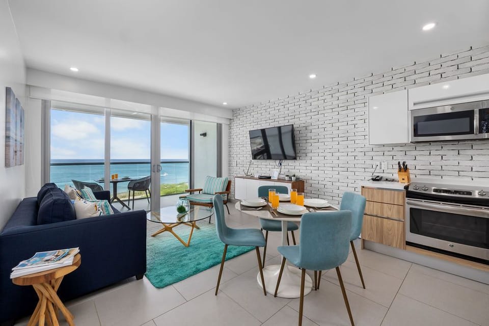 Step into your bright, open living space where modern coastal style meets comfort. Gather around the dining table with ocean breezes drifting in, or unwind on the sofa as natural light fills every corner.