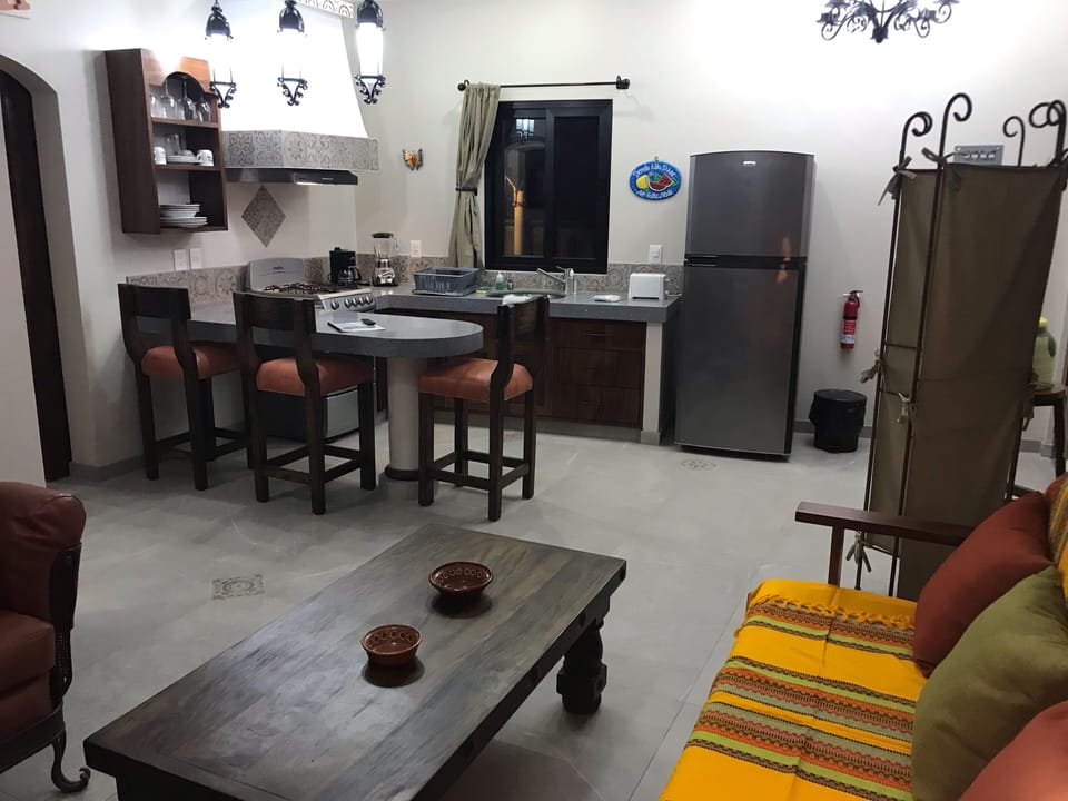 Large island style kitchen with granite counter tops, large fridge and gas oven