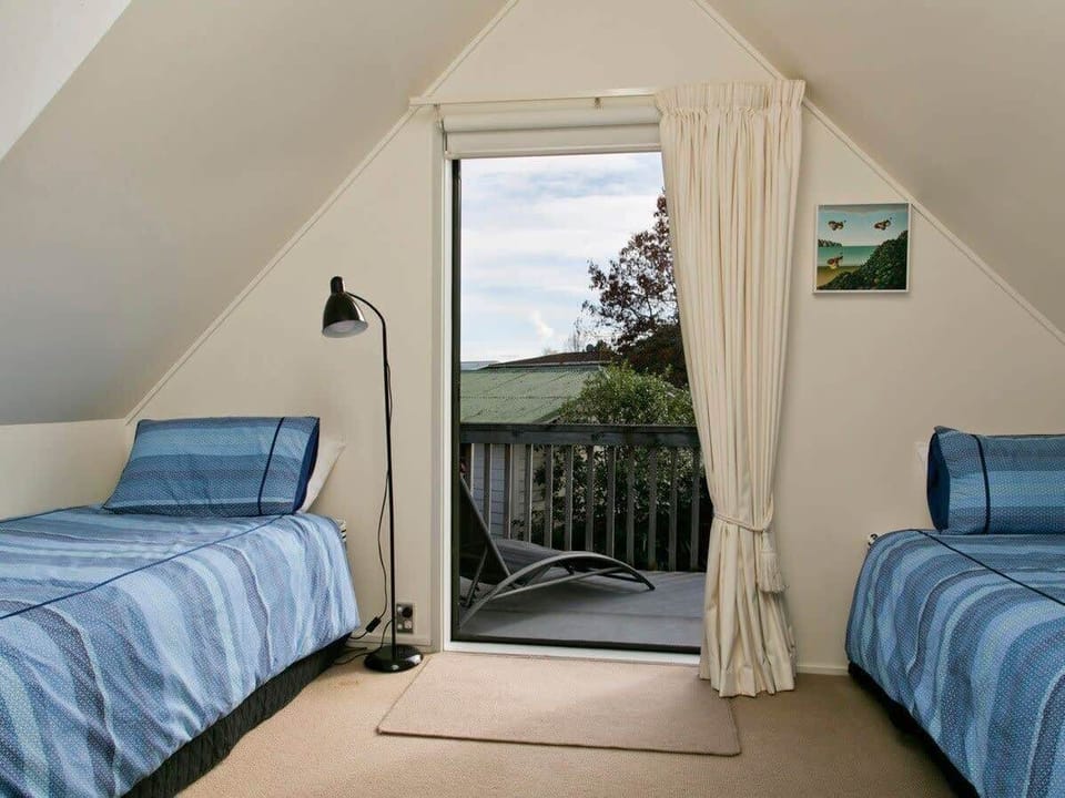 Upstairs twin bedroom opens to a balcony