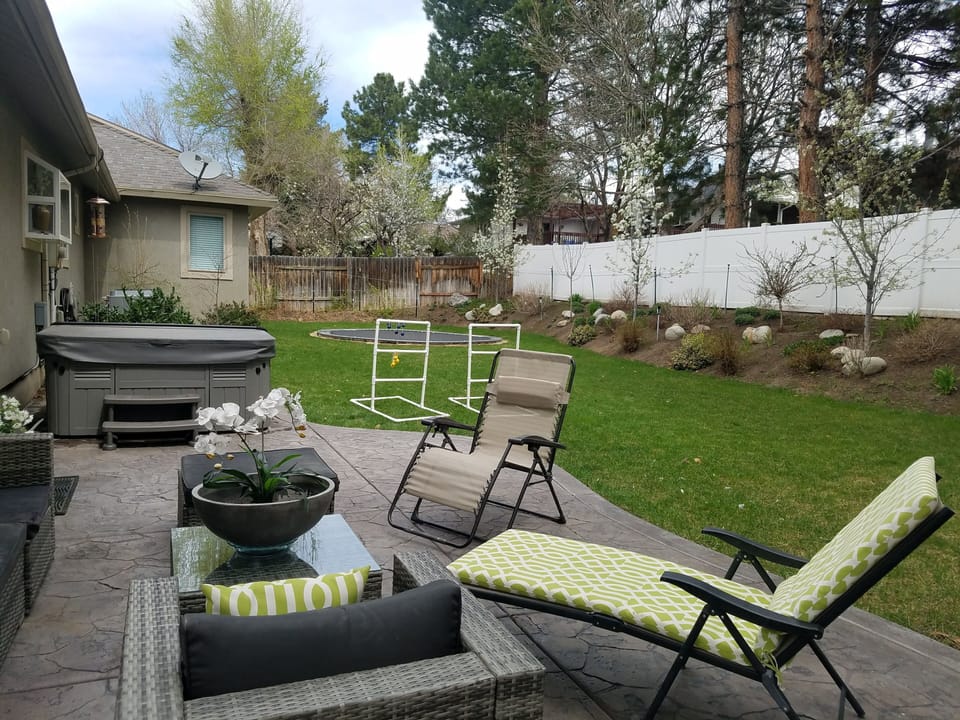 Private beautifully landscaped backyard with in-ground trampoline.