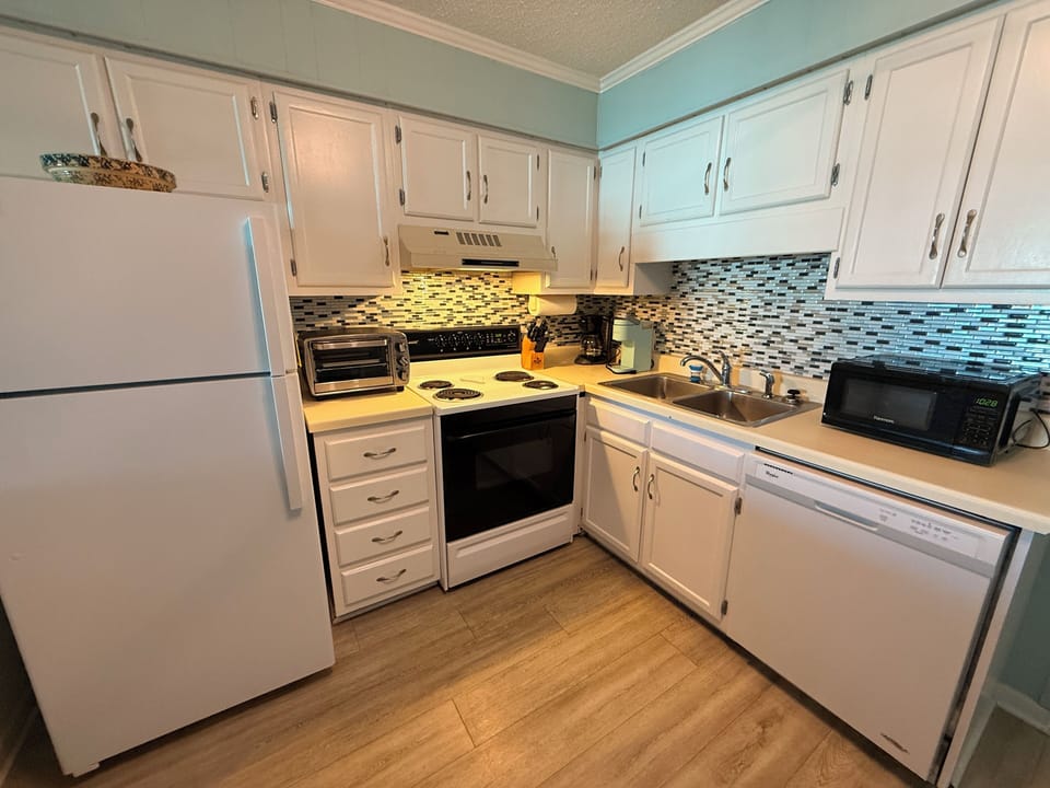 Fully equipped kitchen includes a toaster oven, Keurig, & microwave.