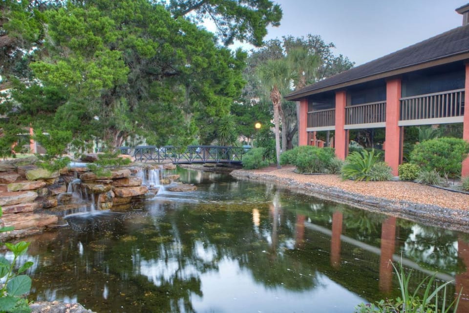 Wander past waterfalls and bridges in a peaceful garden setting.