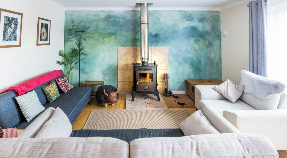 comfortable spacious living room with views to village and hills beyond