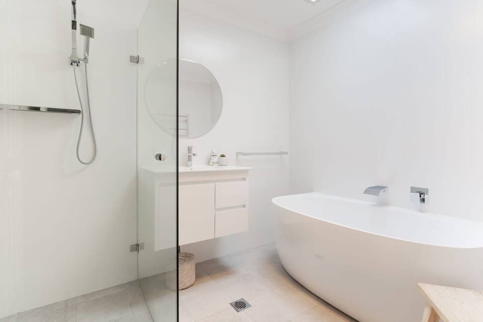 Main bathroom with large bath and separate shower.