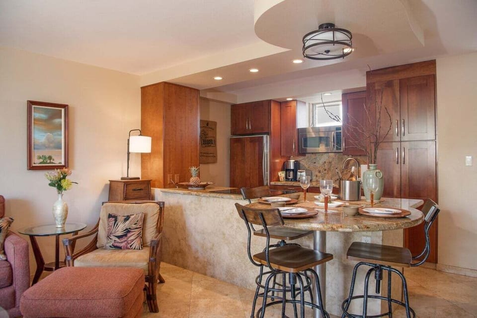 An open dining and kitchen layout features rich wood cabinetry and a spacious design ideal for effortless island living.