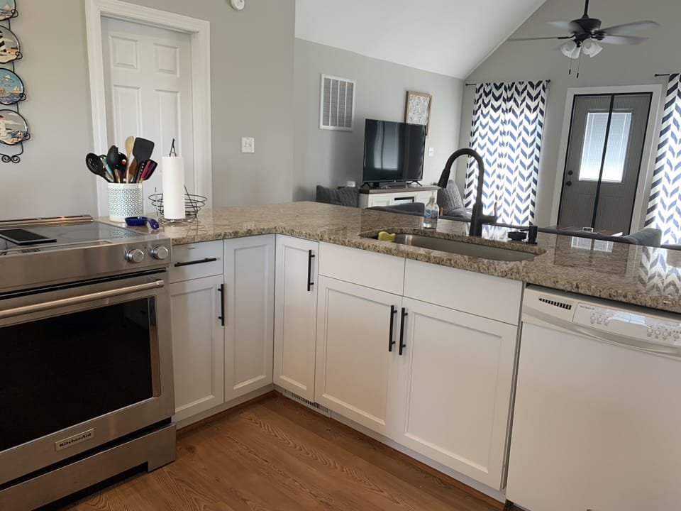Kitchen with granite; looking towards living room and upper deck