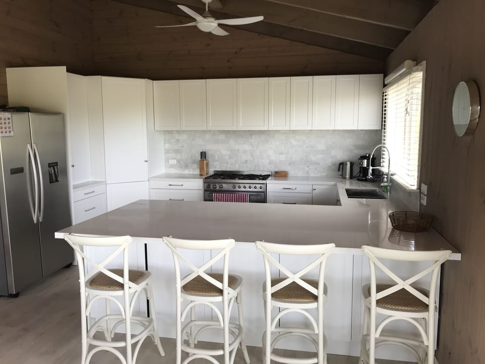 Main kitchen with huge breakfast bar and 6 burner cooktop