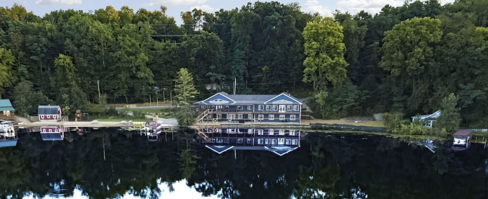 The house sits on 340 ft of lake frontage w/ beach & 2 grassy, level play areas.