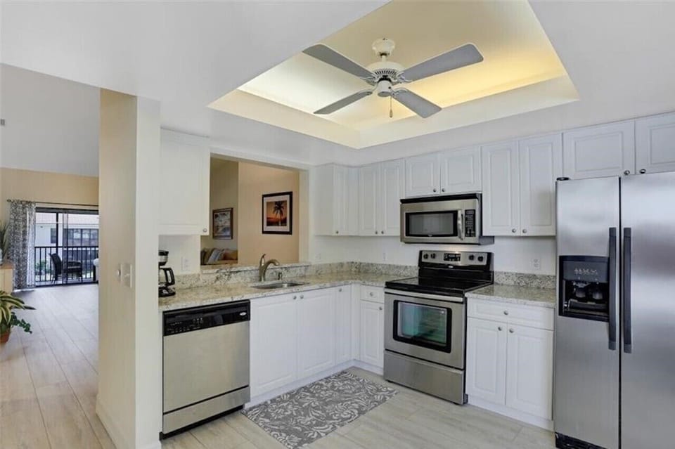 Kitchen with newer stainless steel appliances and granite countertops.
