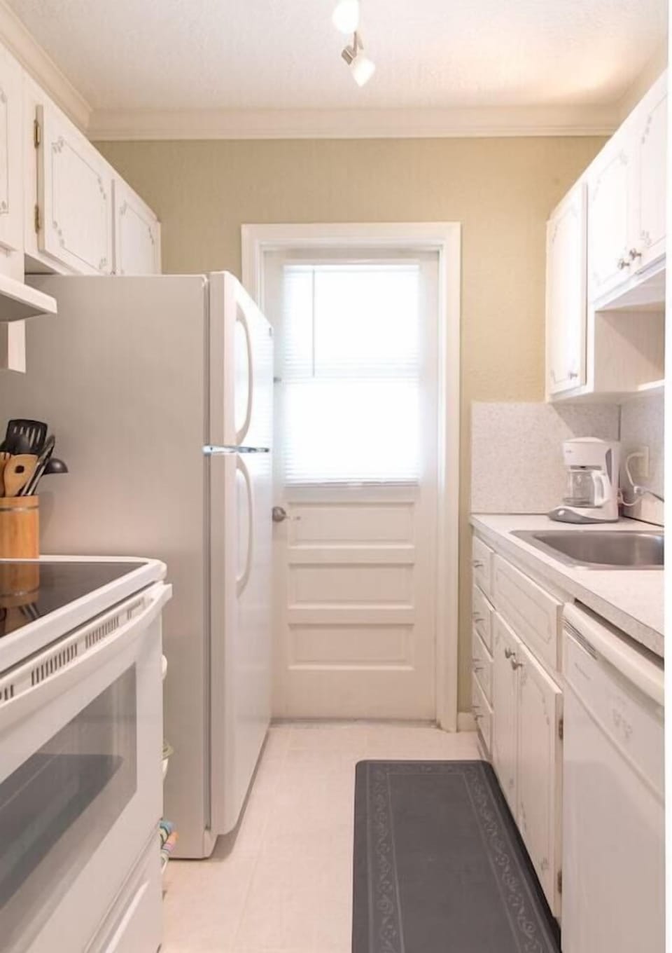 Galley kitchen includes all major appliances (refridgerator, microwave, dishwasher, oven).