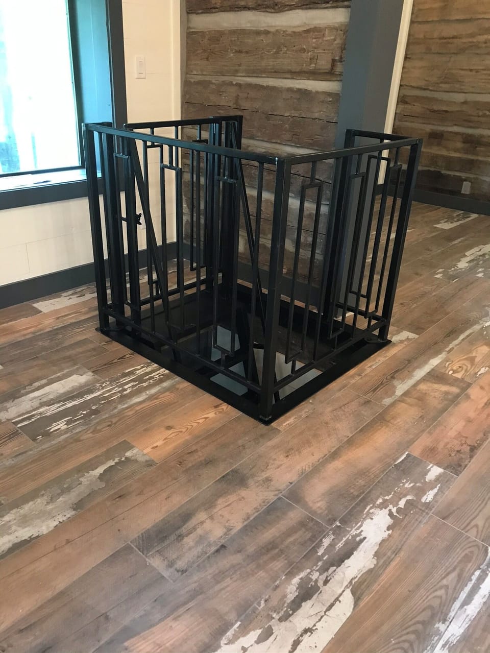 Custom iron gate around open floor ladder entry to root cellar double bedroom