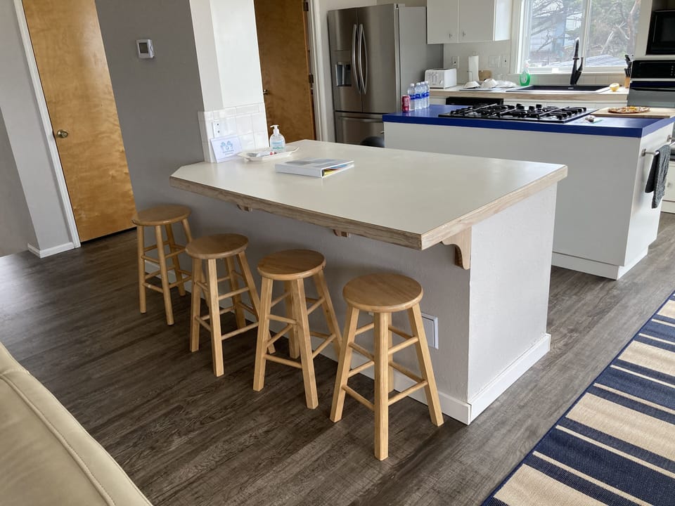 Between kitchen and living room, 4 can sit and enjoy