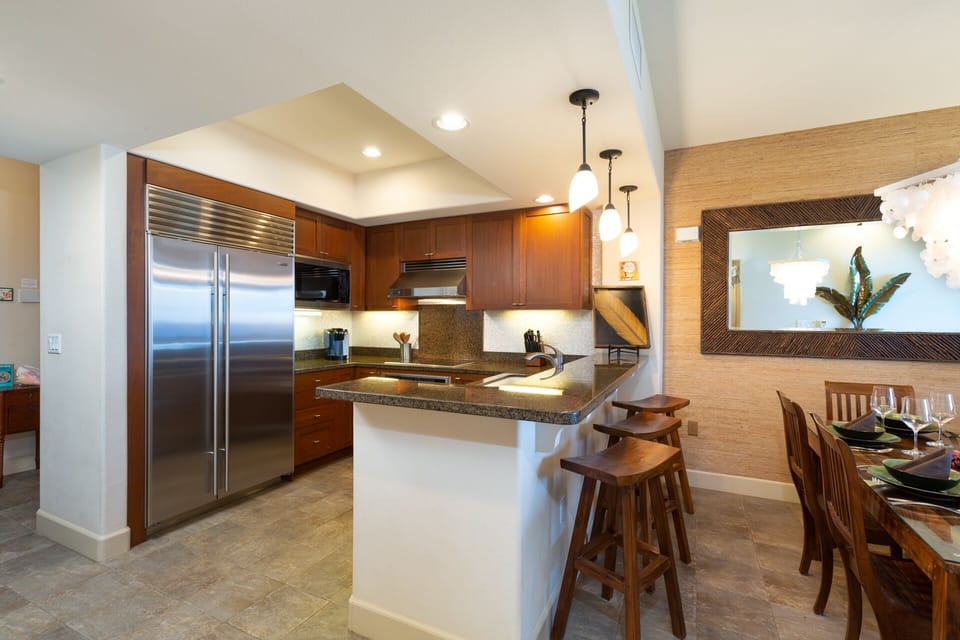 Fully equipped kitchen with breakfast bar, granite counters and stainless steel appliances