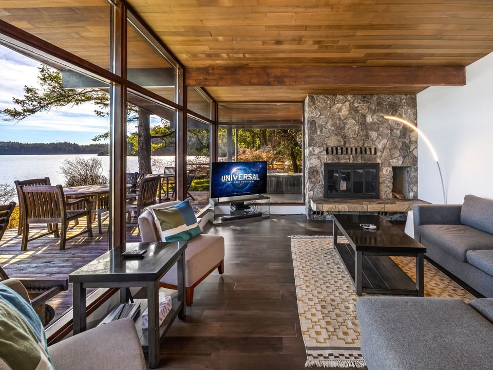 Living room with water views - Enjoy use of the electric fireplace.