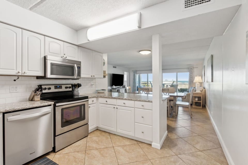 Luxury Fully Equipped Kitchen with Stainless Steel Appliances, Stunning Granite Counters, and A Decorative Subway Tiled Backsplash