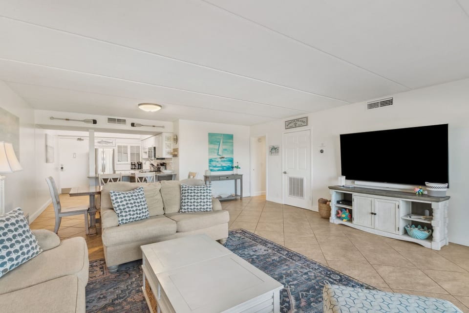 Beautiful Living Space with Magnificent Ocean and Pool Views, a Large Flat Screen Smart TV, and a Slider to the Terrace