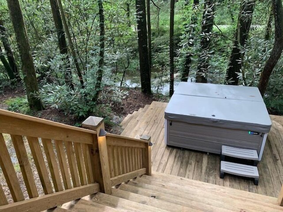 Sit in the hot tub and enjoy the sounds of the rushing Holly Creek