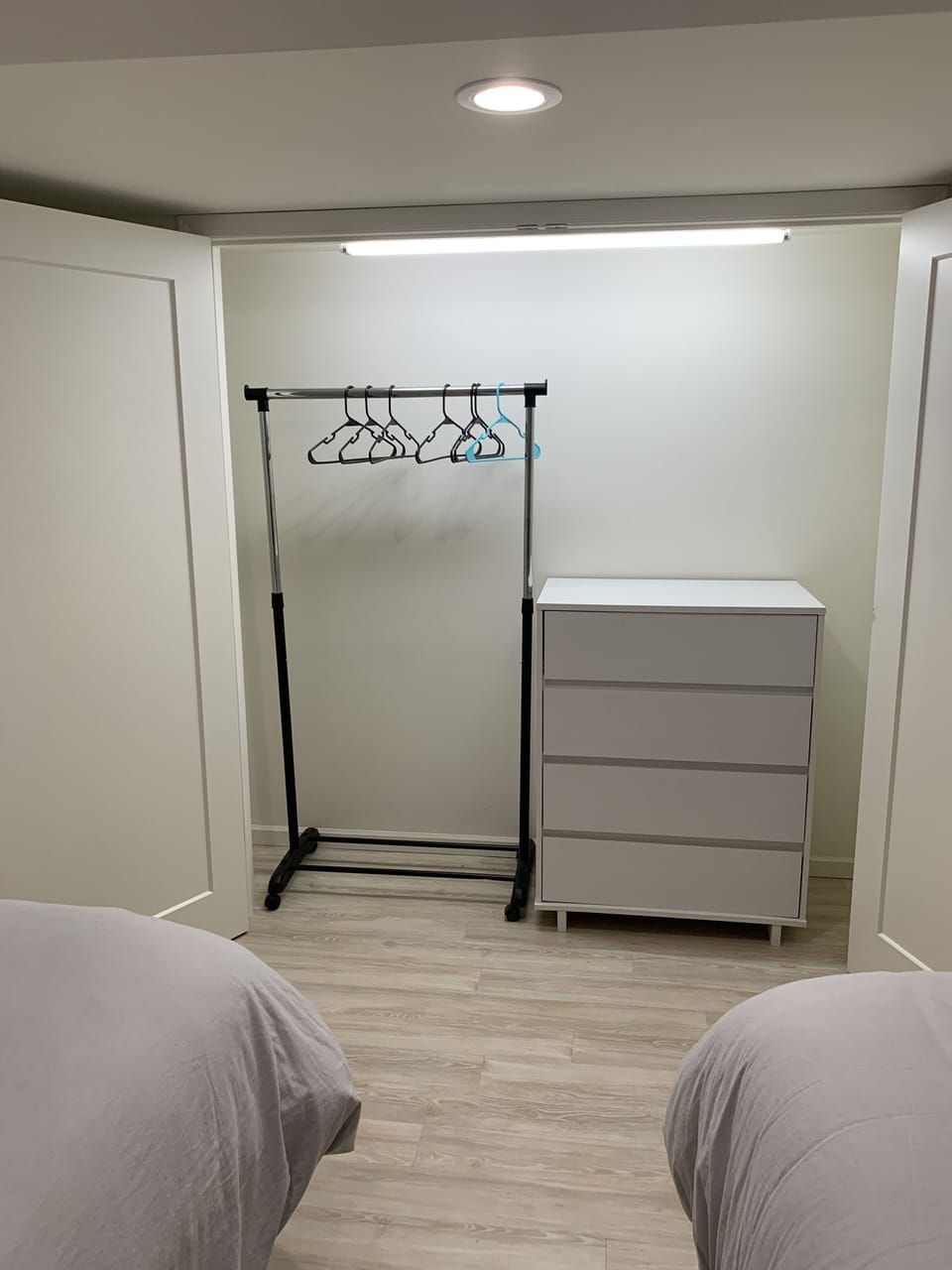 Basement bedroom closet, dresser and hanging rack