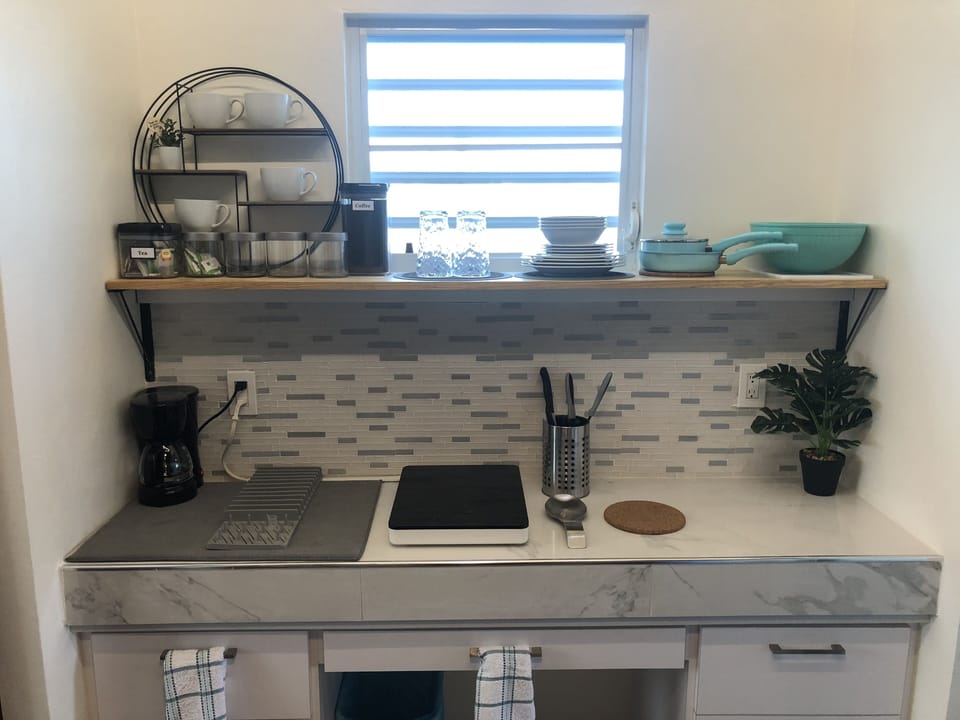Features an induction cooktop and cookware, coffee maker, air fryer & blender