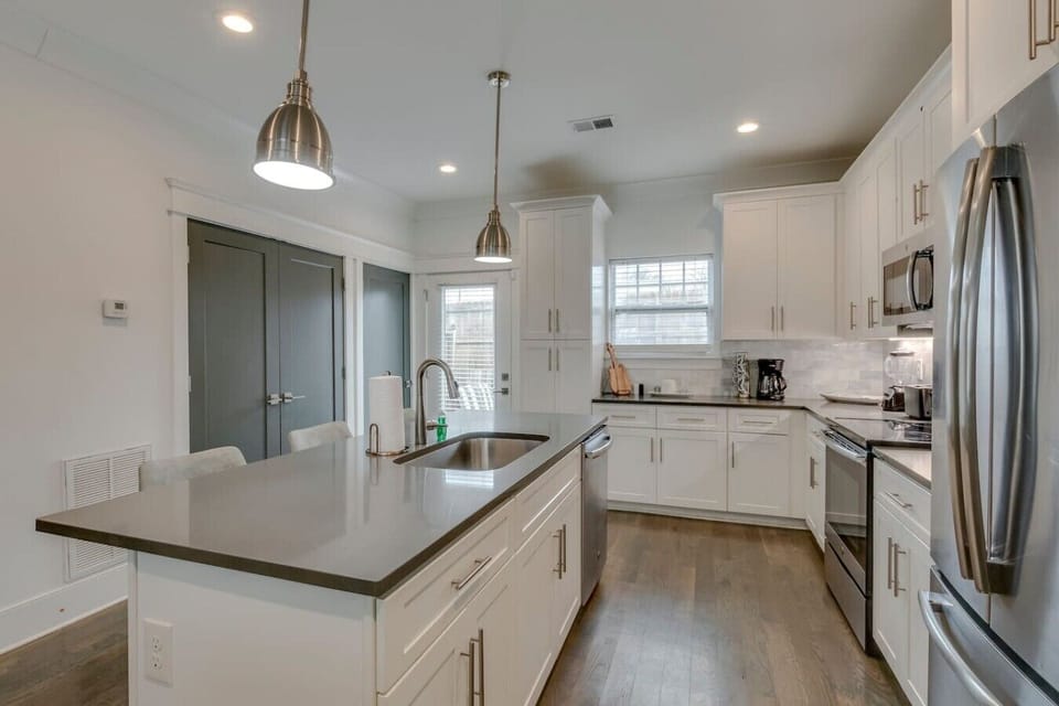 Sleek kitchen with island seating and stainless appliances