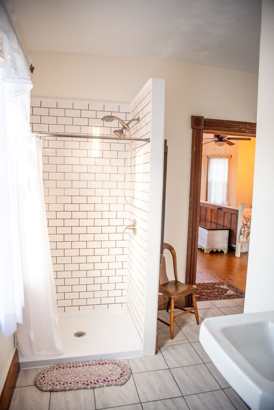 A subway tile shower is part of the full bath. 