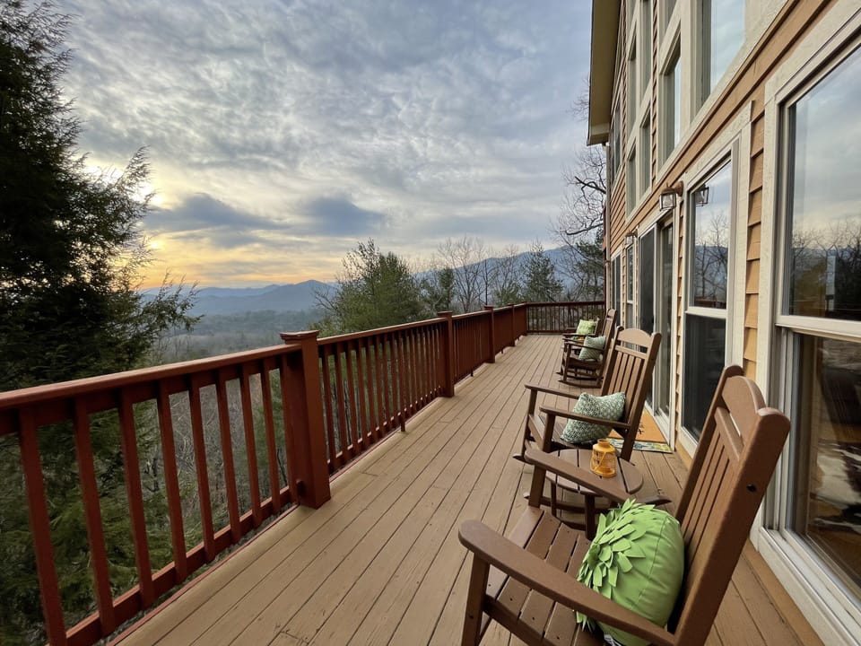 The deck outside the living room is lined with furniture for your whole group