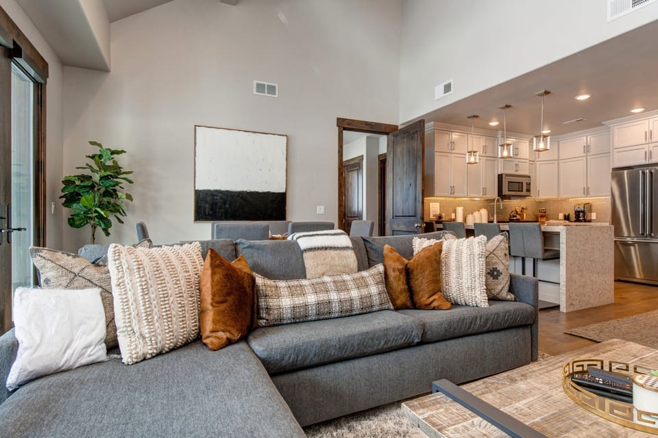 Professionally decorated Living Room with 55" Samsung smart tv, gas fireplace, large sectional sofa with sleeper, and breathtaking views of the Canyons Golf Course and Resort