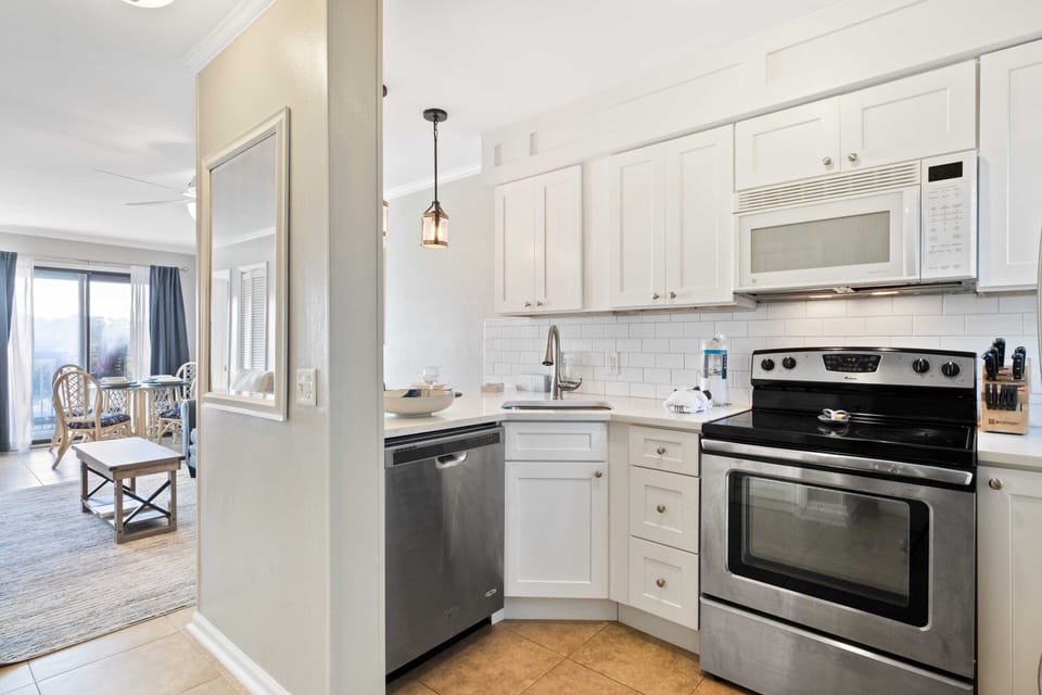 Kitchen features a full-size frig, stove, oven, dishwasher, and blender.