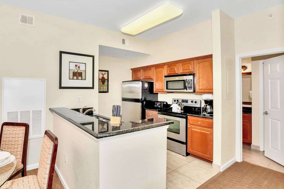 Modern Kitchen With Granite Countertops And Stainless Steel Appliances