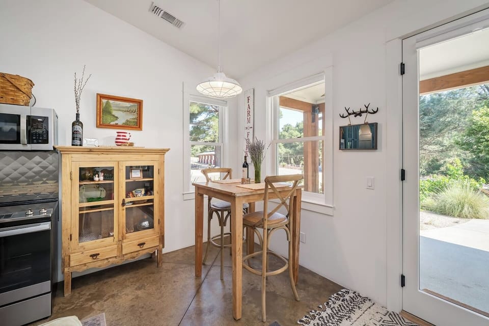 Dining table with view of the farm and the barn.  There is also a dining table outside on the covered porch. 