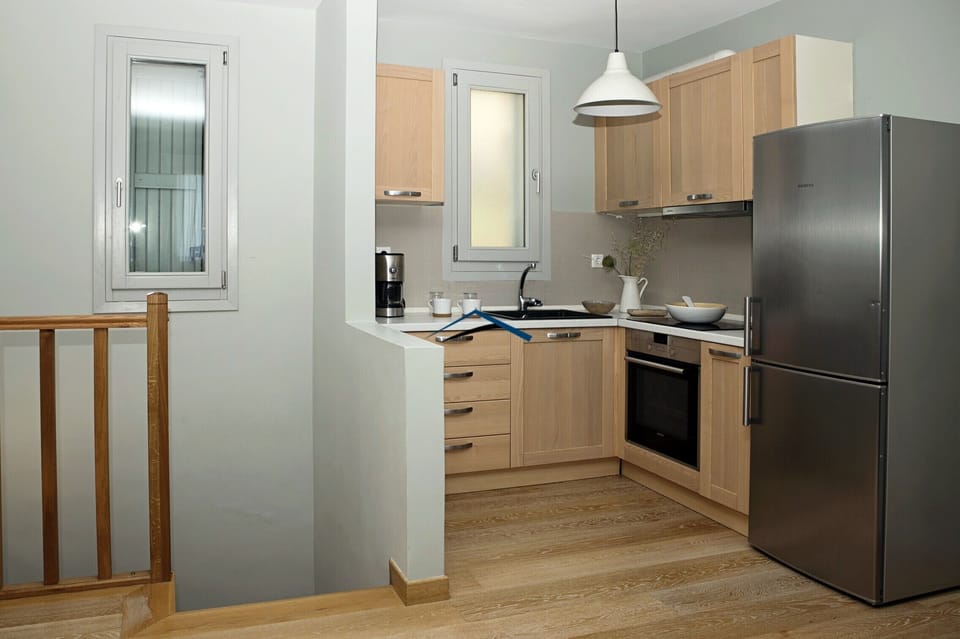 The kitchen with stairs leading to the lower level with the bedrooms